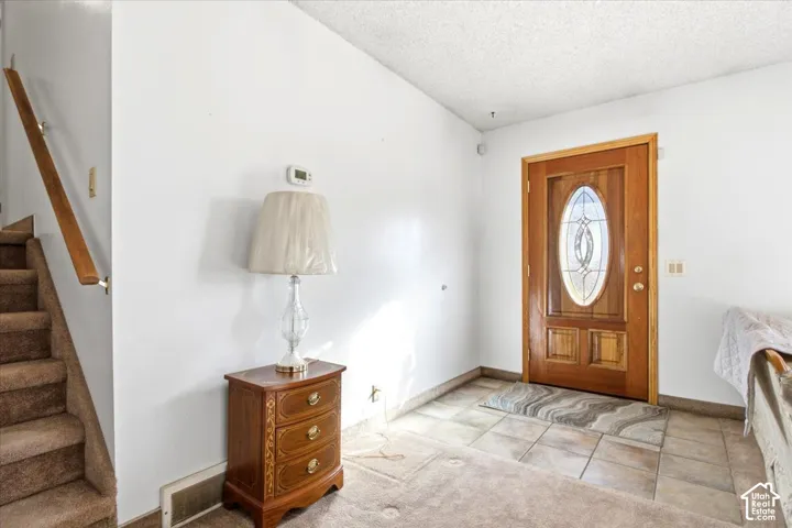 Wood entry door with oval leaded glass insert