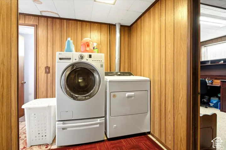 Wood-finish wall paneling with a drop ceiling and red flooring