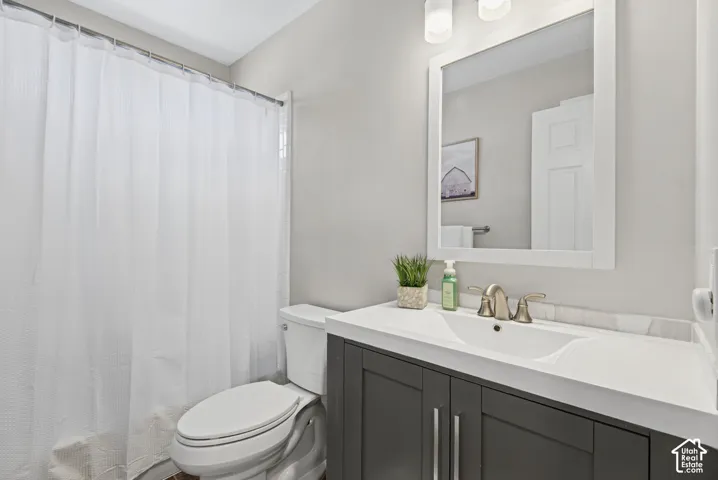 Single vanity with cabinetry, integrated sink, and brushed nickel hardware