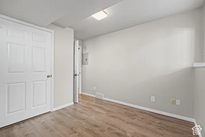 Wood-finish flooring, light grey wall paint, and white trim