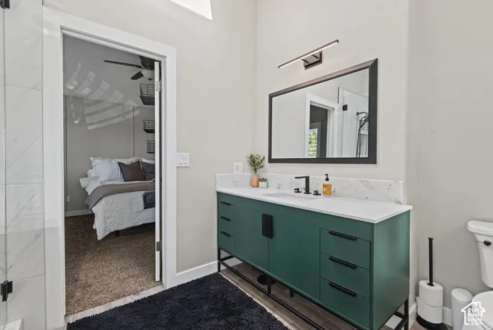 Bathroom vanity with a white countertop, under-mount sink, and matte black faucet
