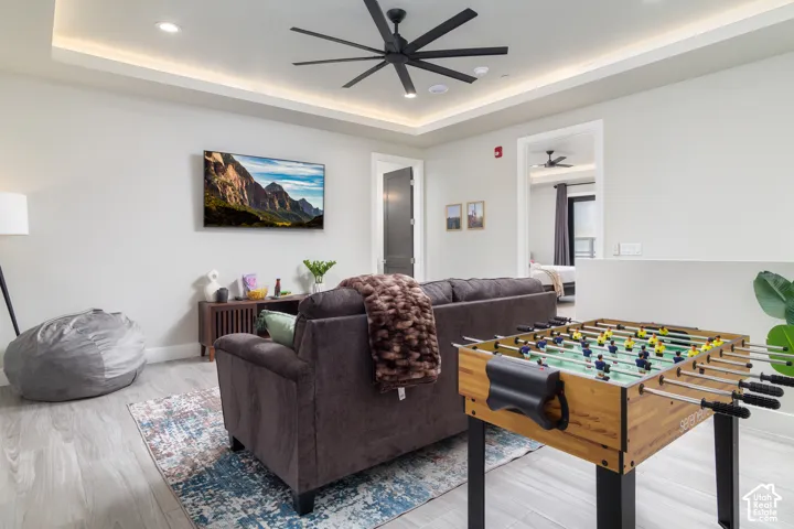 Tray ceiling with recessed lighting and a central ceiling fan