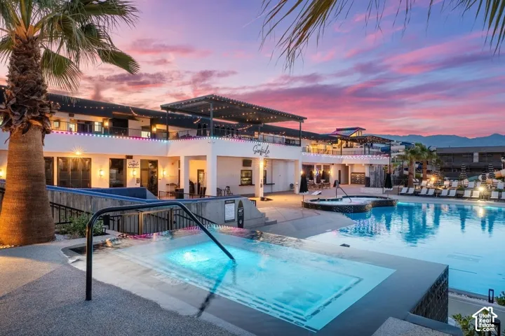 Expansive swimming pool with integrated spa and surrounding lounge deck