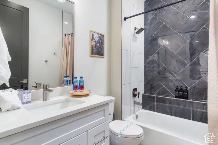 White vanity with a rectangular sink and brushed nickel faucet