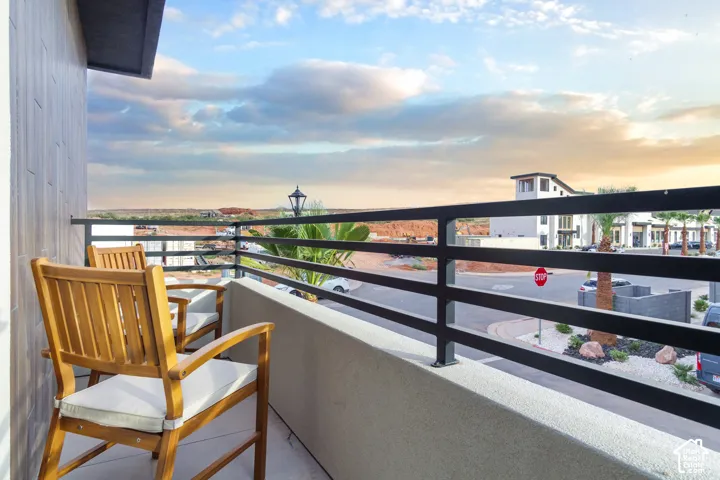 Balcony with metal railings and a textured exterior wall