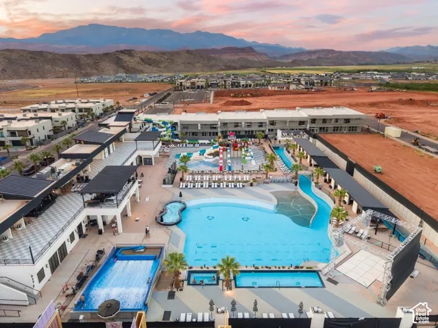 Expansive aquatic amenities featuring a large resort-style pool, leisure river, and surf simulator
