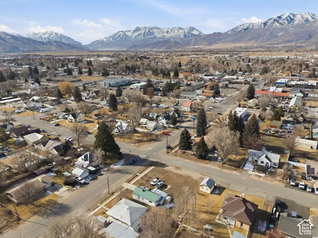 Aerial perspective showcasing a residential and commercial area with prominent mountain backdrops