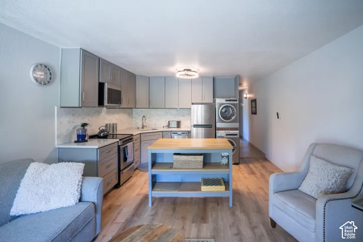 Kitchen featuring stainless steel appliances, light gray cabinetry, and a subway tile backsplash
