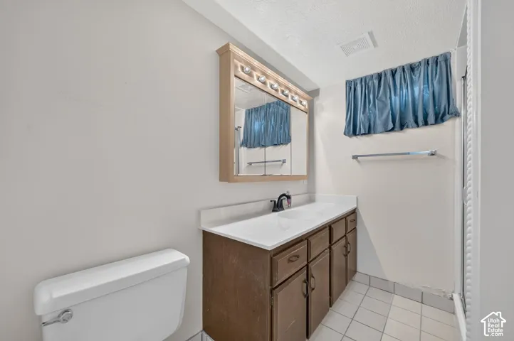 Wood-finish vanity with white countertop and integrated sink