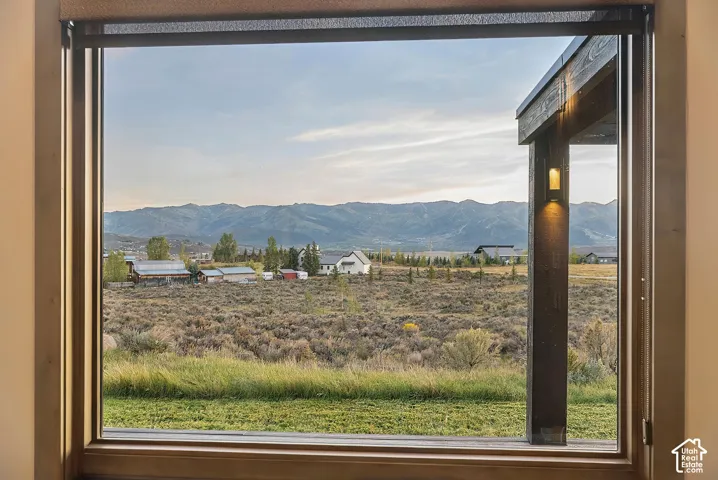 Expansive window with roller shade, framed by wood trim