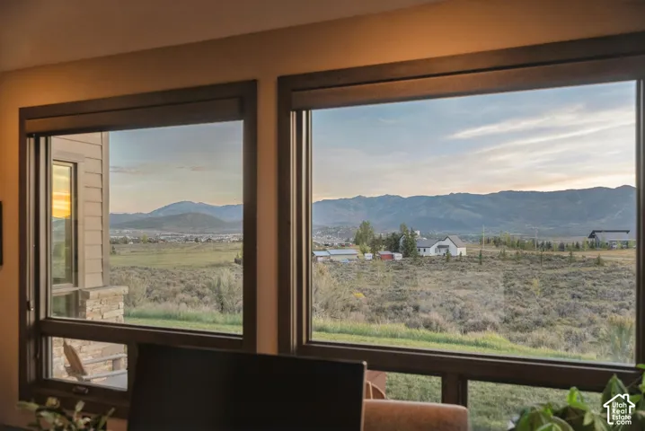 Expansive landscape beyond large windows with dark wood-finish frames