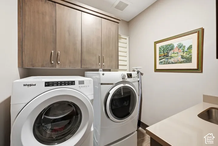 Built-in wood-finish cabinetry, countertop with integrated sink, and tiled flooring