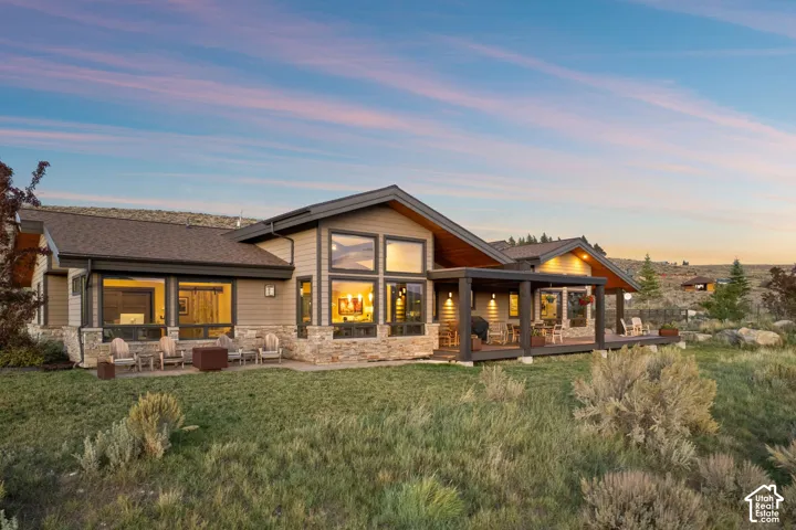 Modern ranch-style exterior with wood siding and stone accents