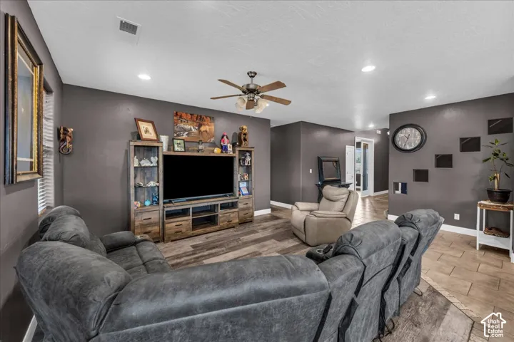 Recessed lighting, wood-finish flooring, ceiling fan, and painted walls