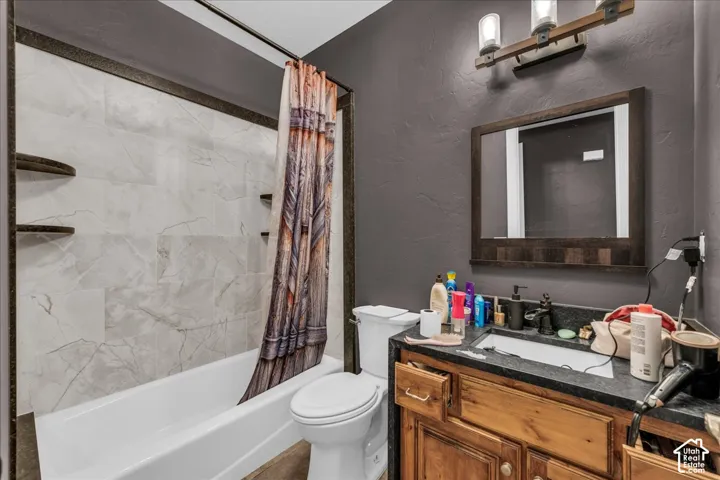Integrated bathtub and shower with light-toned wall tile and dark trim