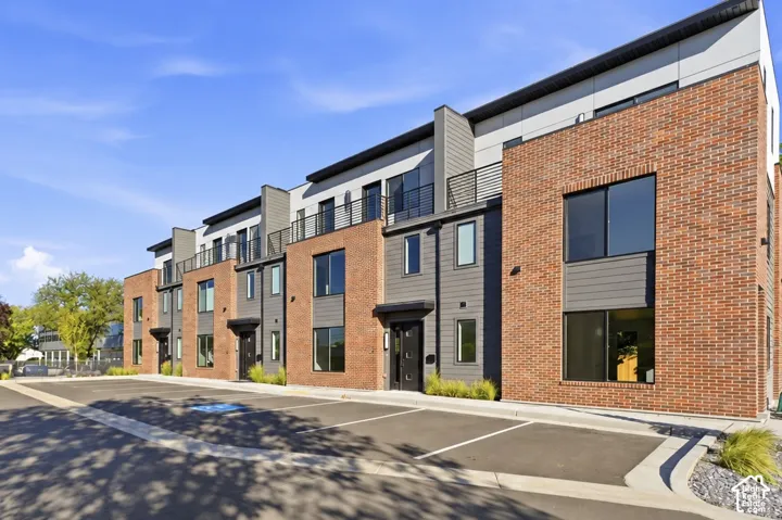 Modern townhome architecture featuring brick and horizontal siding