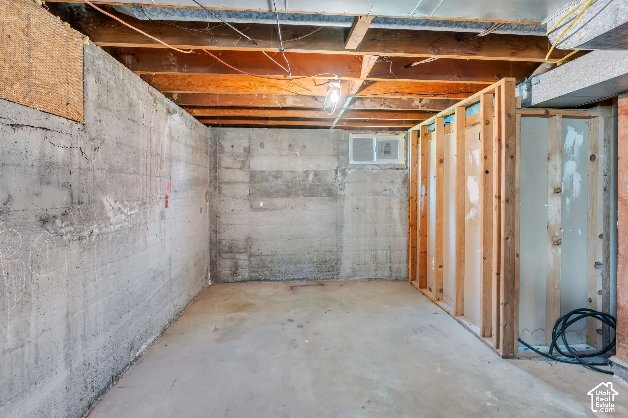 Concrete foundation walls with exposed wood ceiling joists