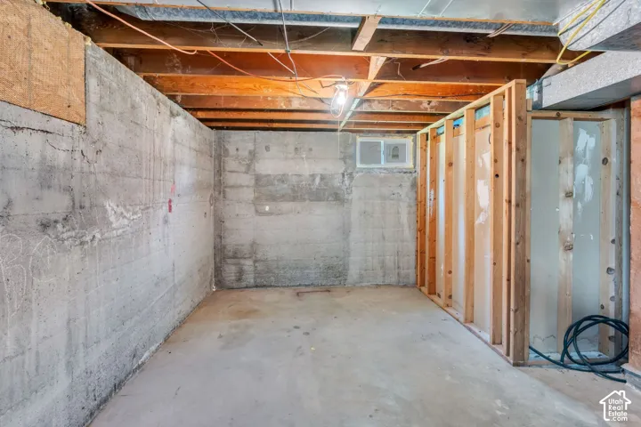 Concrete foundation walls with exposed wood ceiling joists