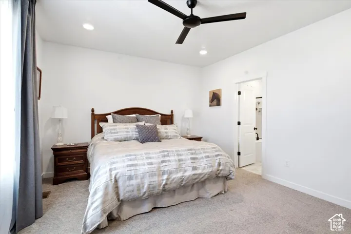 Primary suite with walk-in closet, double vanity, separate tub and shower, and tucked-away linen storage.