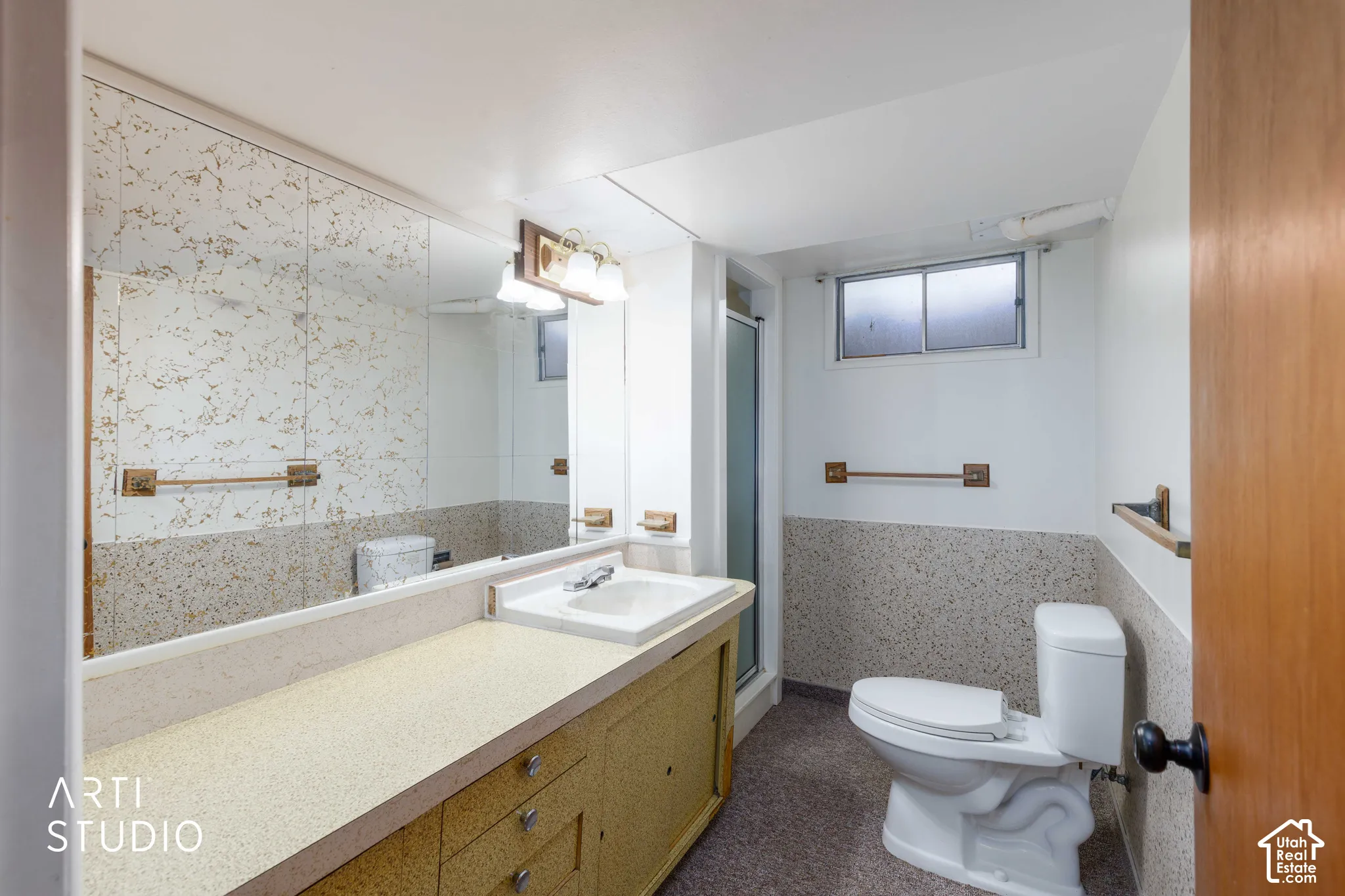 Full-width vanity with integrated sink, patterned countertop, and mirrored wall