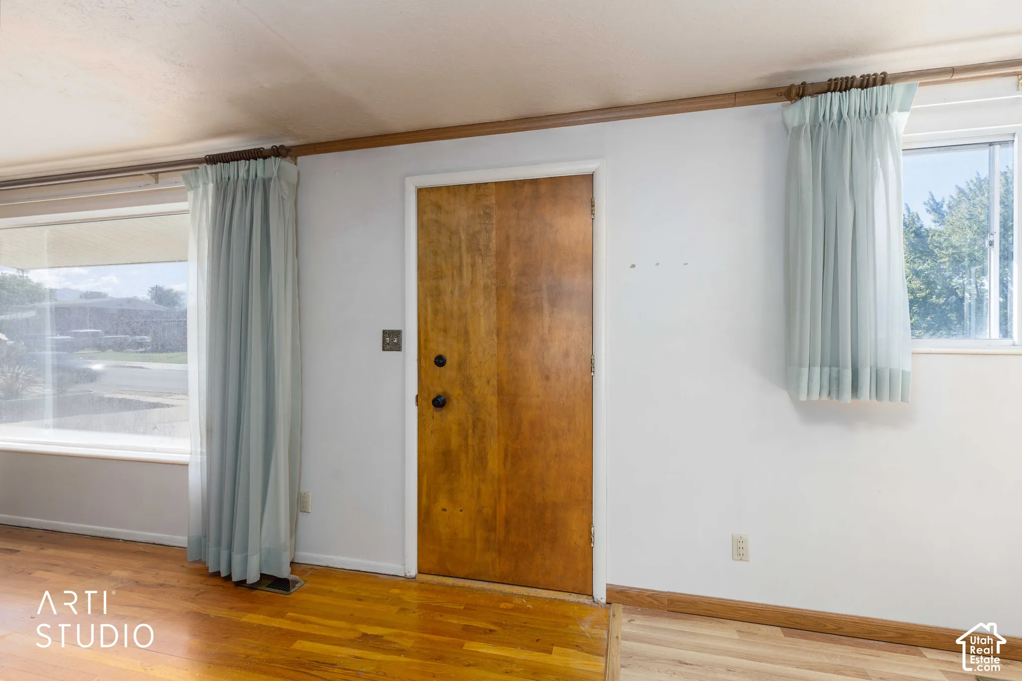 Wood-finish flooring with white wall finishes and natural wood trim accents