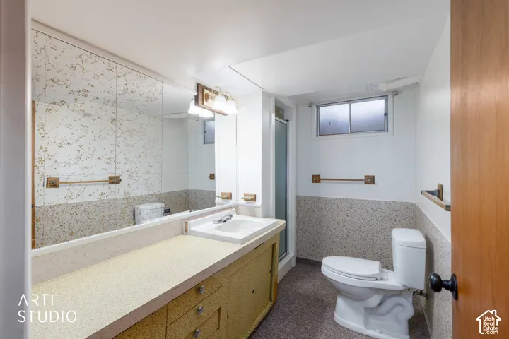 Full-width vanity with integrated sink, patterned countertop, and mirrored wall