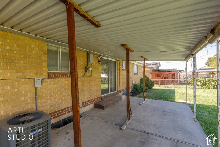 Patio featuring a concrete surface, covered roof structure, and brick exterior