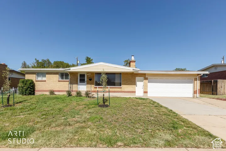 Brick and siding exterior with a front porch, an attached two-car garage, and a concrete driveway