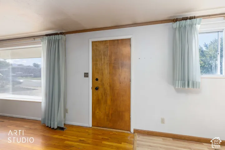 Wood-finish flooring with white wall finishes and natural wood trim accents