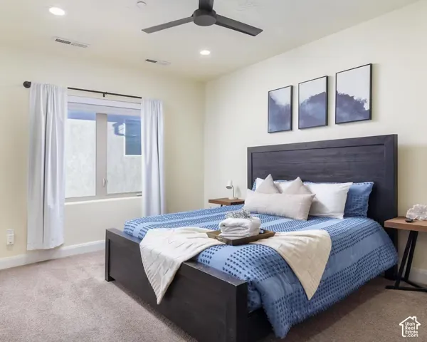 Recessed lighting, ceiling fan, and window with white curtains