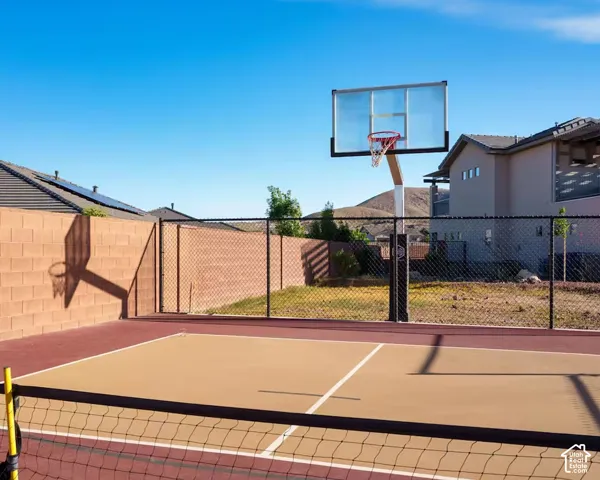 Multi-sport court with designated playing lines and a basketball hoop