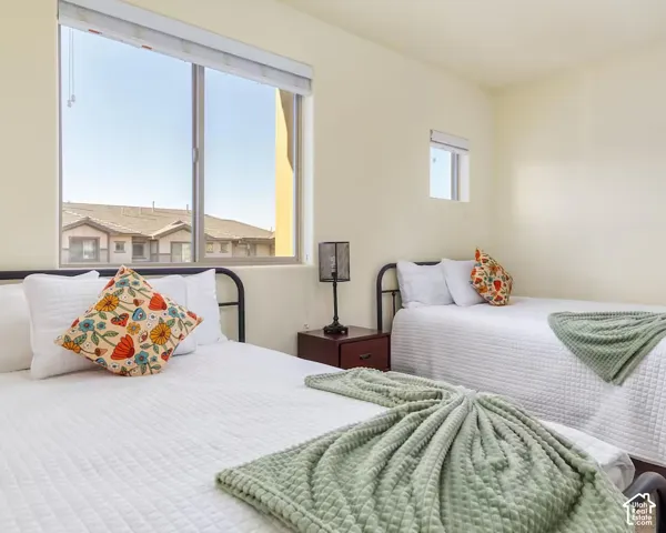 Neutral wall tones, two distinct windows, and durable bed frames