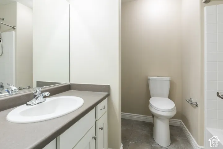 Vanity with integrated sink, chrome faucet, and under-counter cabinetry