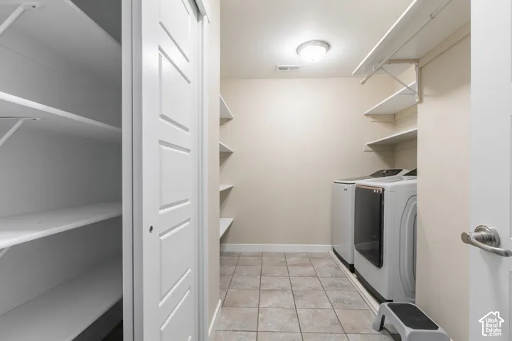 Tile flooring, recessed lighting, and built-in shelving offer organized storage
