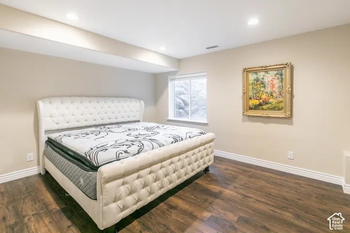 Wood-finish flooring, recessed lighting, and a white-trimmed window