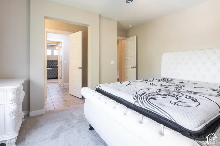 Recessed lighting, light gray carpet, and a light-toned interior paint palette
