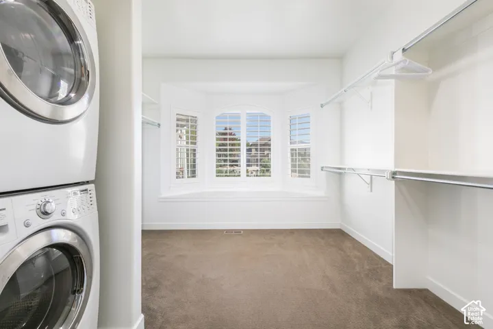 Integrated stackable washer and dryer, bay window with plantation shutters, window seat, and built-in closet shelving and hanging rods