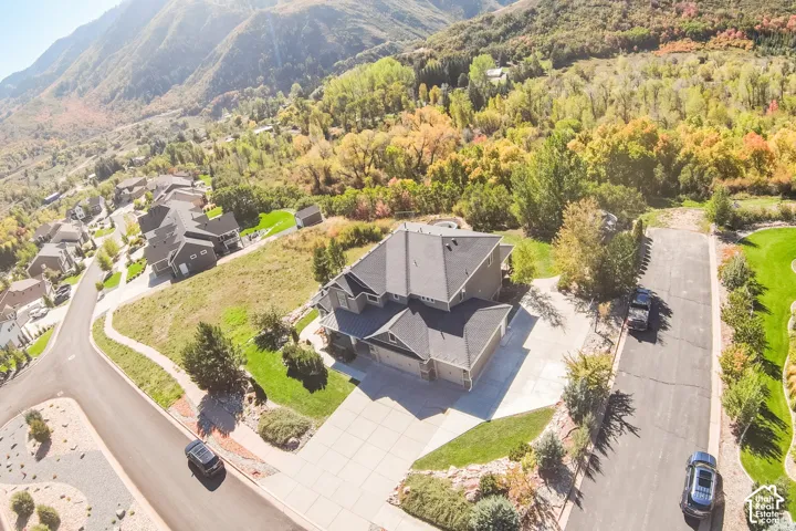 Contemporary residence featuring a multi-level roofline, attached garage, and concrete driveway
