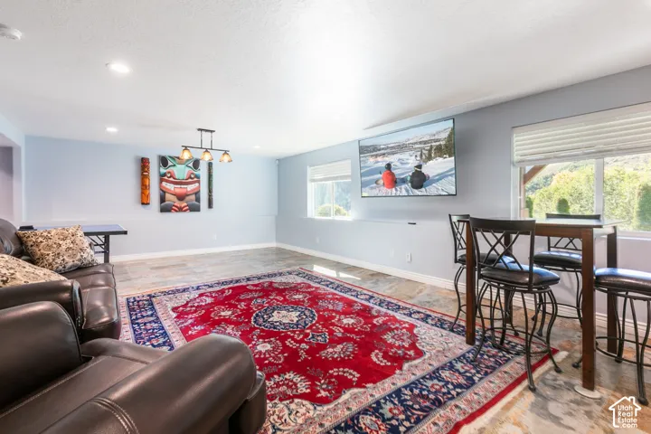 Recessed lighting, wood-finish flooring, multiple windows, and a wall-mounted light fixture