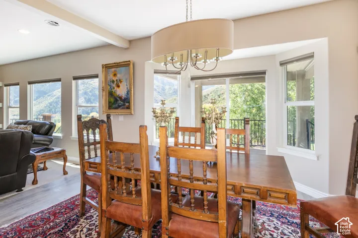 Bright interior with multiple windows, recessed lighting, and a prominent decorative chandelier