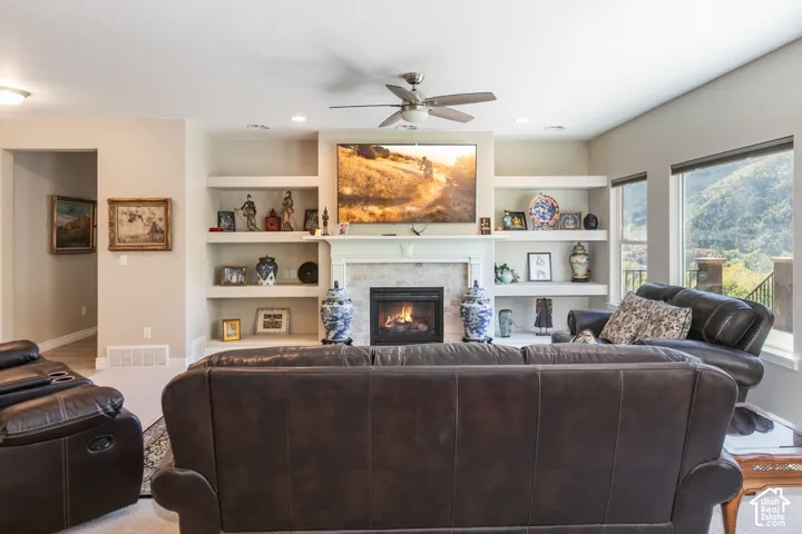 Built-in shelving flanking a central fireplace with stone surround and mantle