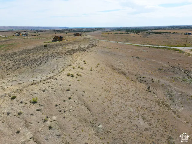 Expansive undeveloped land featuring natural terrain and distant structures
