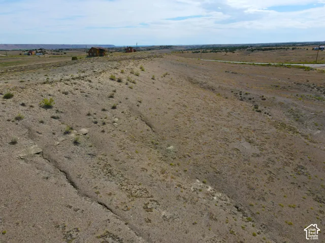 Expansive undeveloped land featuring natural terrain and distant structures