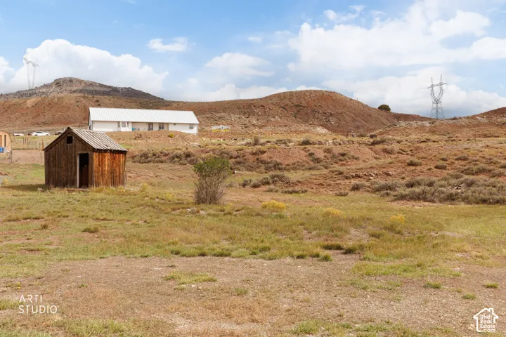 Expansive land parcel featuring natural vegetation and distant hills