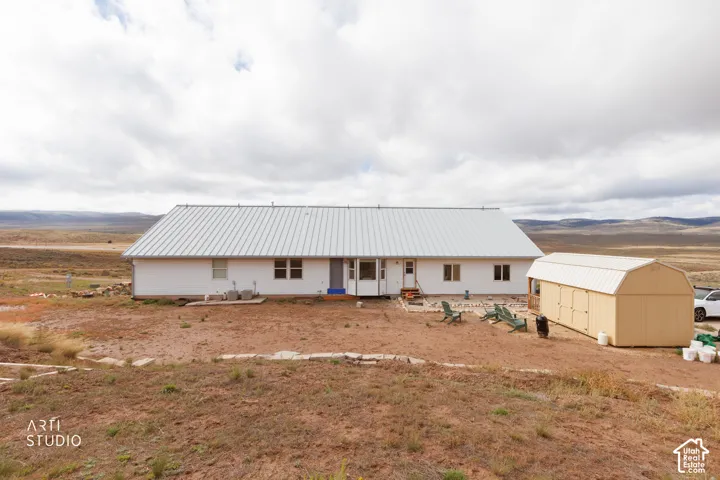 Single-story residence with a metal roof and light-colored siding