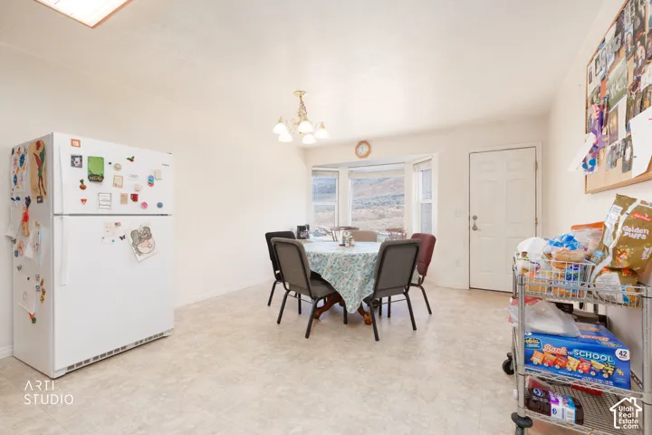 Bay window, flush-mount ceiling light, white paneled door, and neutral flooring
