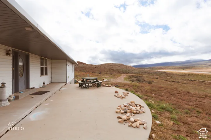Expansive concrete patio with direct outdoor access and surrounding natural landscape