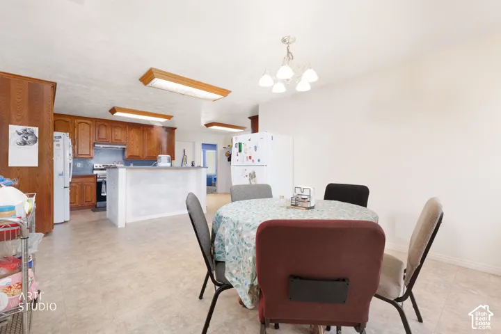 Kitchen and dining area featuring wood cabinetry, stainless steel range with hood, and a peninsula
