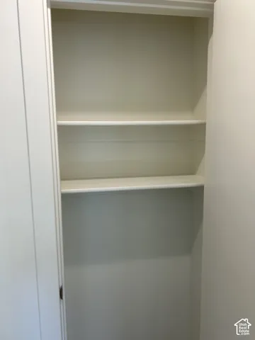 Built-in shelving with three white fixed shelves