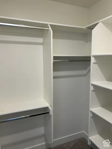 Built-in closet organization system featuring multiple hanging rods and shelving